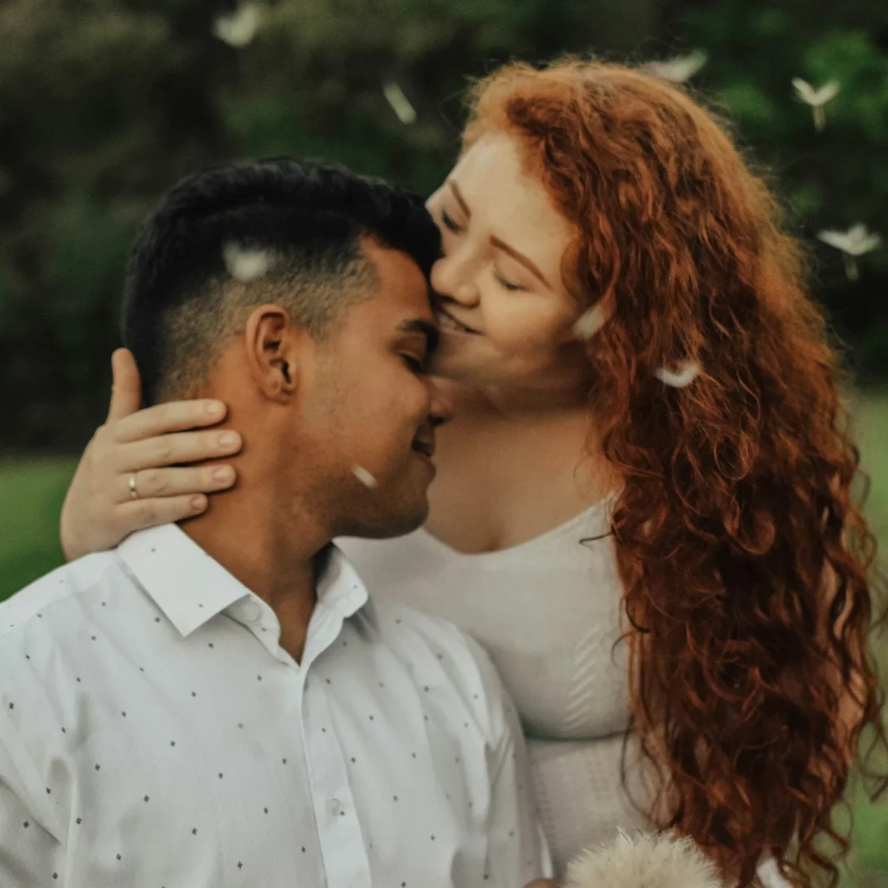 Couple holding each other happy in a park
