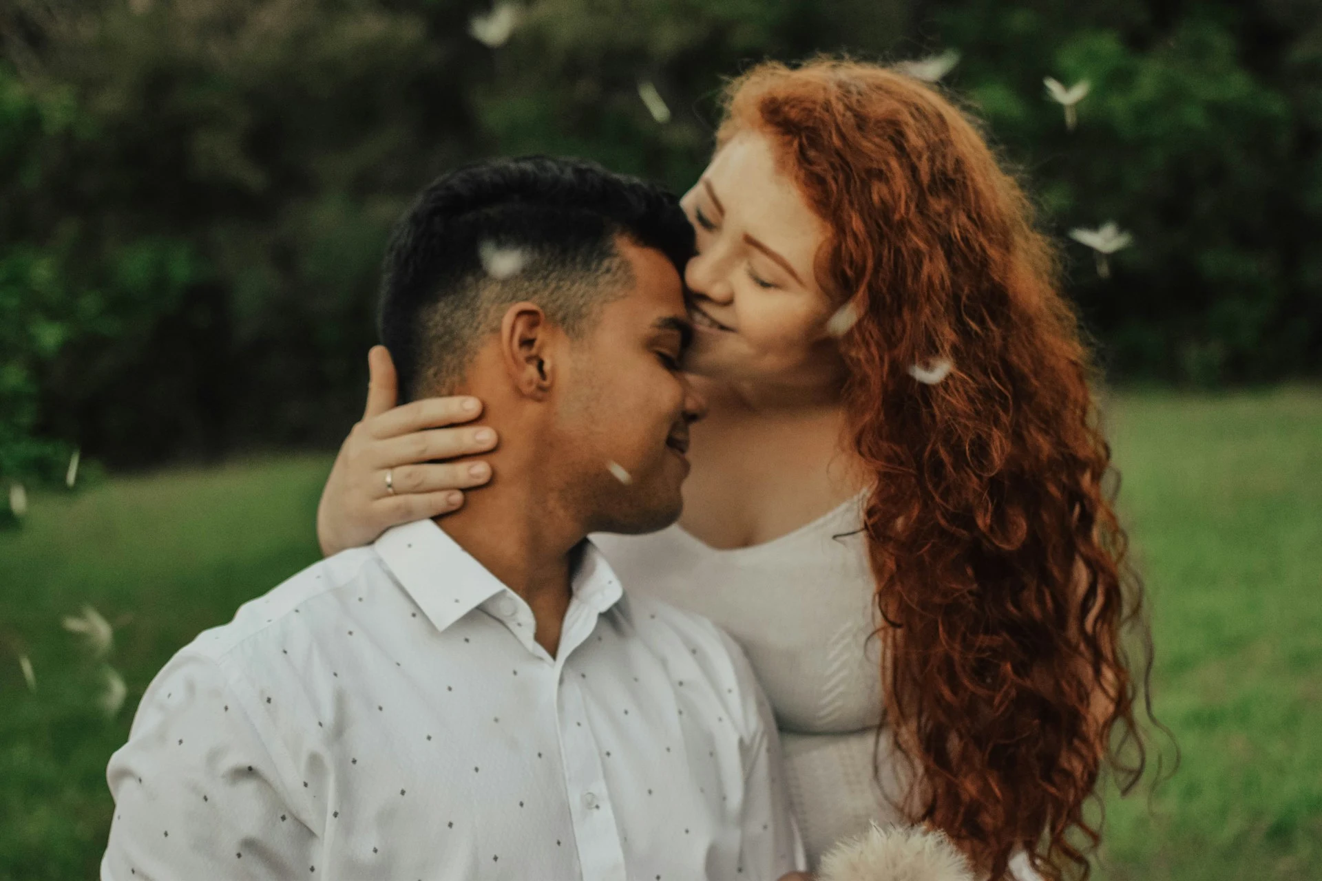 Couple holding each other happy in a park