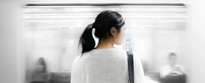 woman watching a subway train pass by