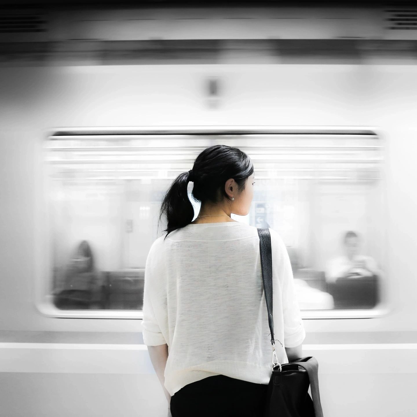woman watching a subway train pass by