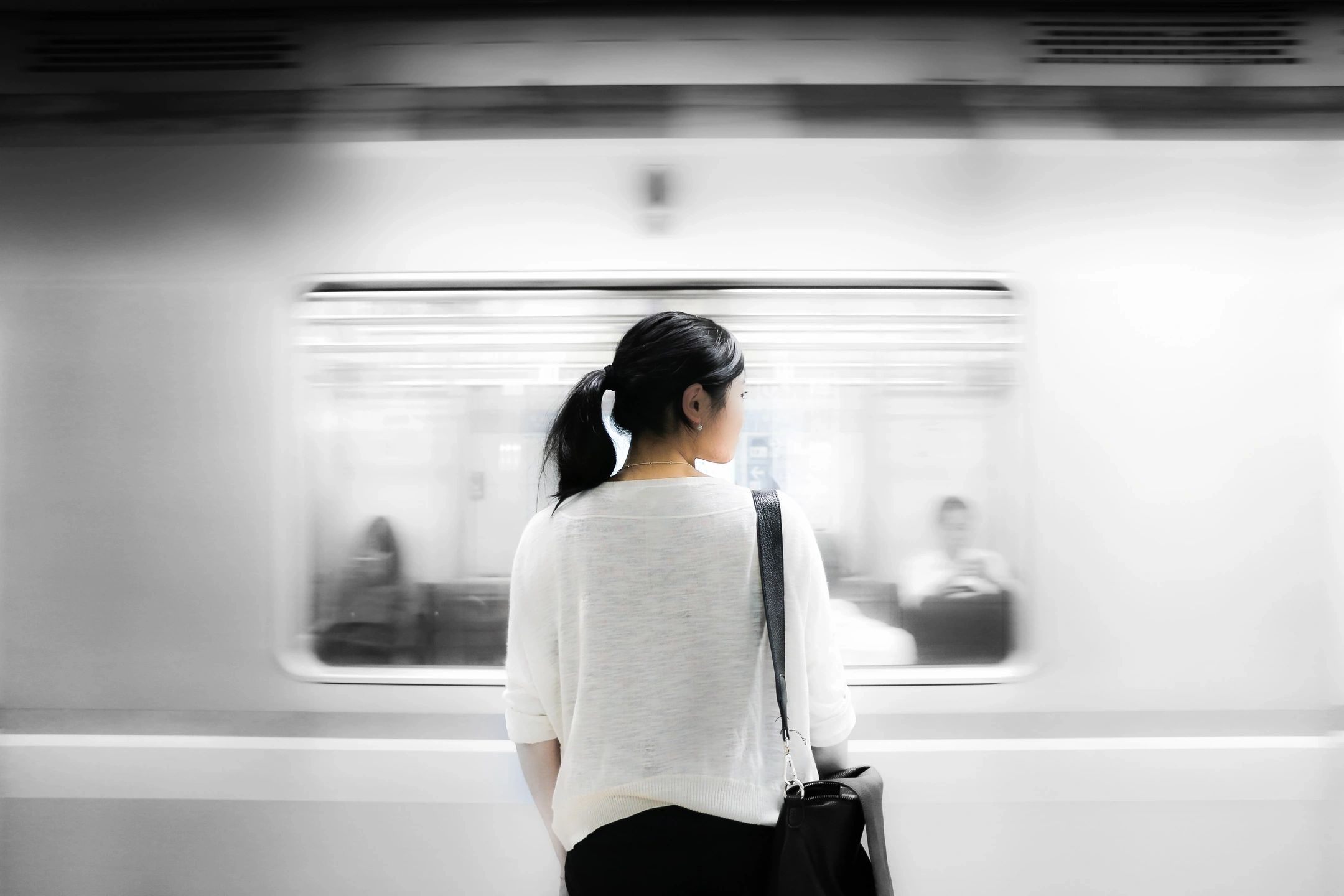 Woman watching subway train pass by