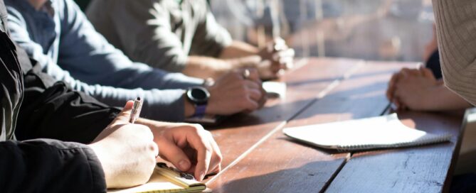 people sitting at a table writing
